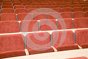 Luxury auditorium with many red chairs