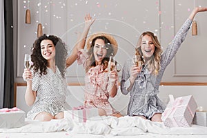 Luxury bachelorette party in posh apartment while happy young th photo