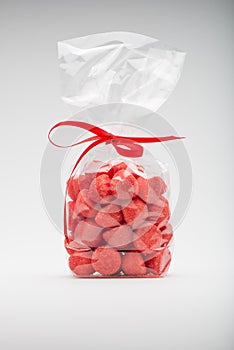 Luxury bag of acidulous strawberries isolated with elegant red r