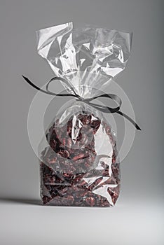 Luxury bag of dried cranberries isolated with elegant black ribbon