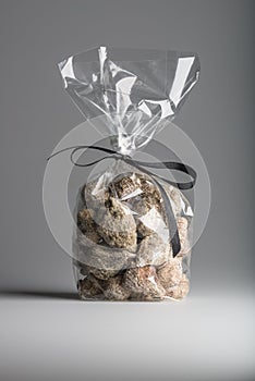 Luxury bag of dried figs isolated with elegant black ribbon