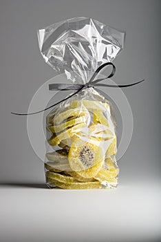 Luxury bag of dried kiwi slices isolated on grey background.