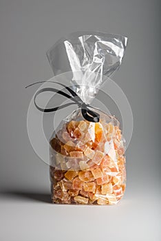 Luxury bag of dried papaya isolated with elegant black ribbon