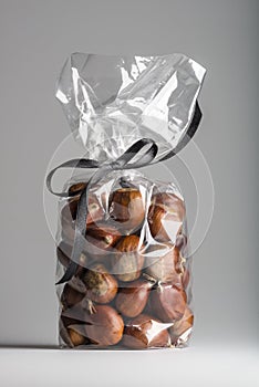 Luxury bag of fresh chestnuts isolated with elegant black ribbon