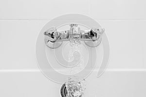 Luxury bath tub and faucet with water.