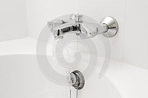Luxury bath tub and faucet with water.