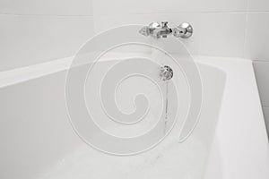 Luxury bath tub and faucet with water.