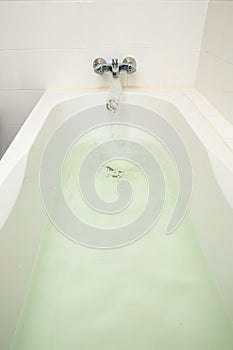 Luxury bath tub and faucet with water.