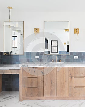 A luxury bathroom with blue tiles and gold accents.