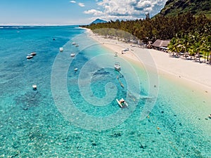 Luxury beach with Le Morne mountain in Mauritius. Beach with palms and ocean. Aerial view
