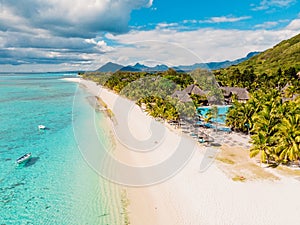 Luxury beach with mountain in Mauritius. Sandy beach with palms and ocean. Aerial view