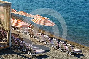 Luxury beach tents with awnings on pebble beach of Gelendzhik. Beautiful resort on the Black Sea