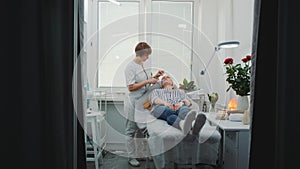 Luxury beauty salon: cosmetician making cavitation facial peeling