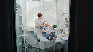 Luxury beauty salon: cosmetician making cavitation facial peeling