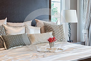 Luxury bedroom interior with brown pattern pillows on bed