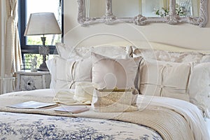 Luxury bedroom interior with decorative set on bed and classic style table lamp