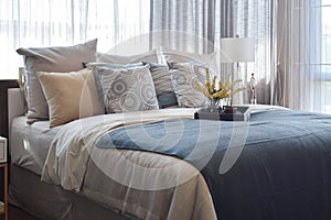 Luxury bedroom with striped pillows and decorative tea set on bed