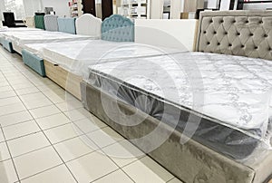 Luxury beds with soft headboards for sale at furniture store