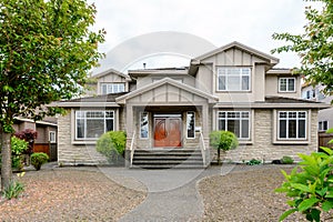 Luxury beige house with a big wooden door