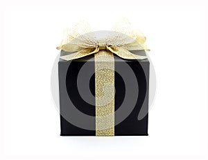 luxury black gift box with glittering gold ribbon and net tied bow isolated on white background