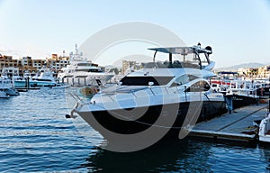 A luxury black and white boat by the bay of Cabo San Lucas, Mexico