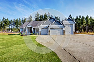 Luxury blue house with curb appeal. Three car garage.