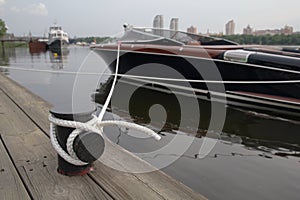 Luxury boat on a leash near the pier
