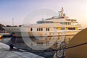 Luxury boats on harbour at sunset