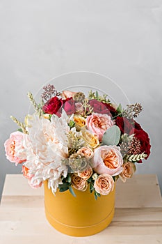 Luxury bouquet of mixed flowers in yelow paper headbox.