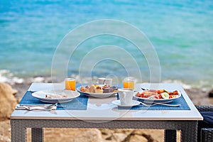 Luxury breakfast spread on table with a stunning tropical sea view