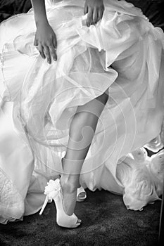 Luxury bride`s shoes under wedding dress
