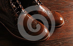 Luxury brown shoes on wood background