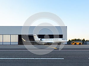 Luxury business jet is being towed out of the hangar