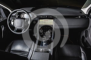 Luxury car inside, automatic gear stick of a modern car. Dark leather interior