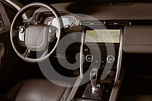 Luxury car inside, automatic gear stick of a modern car. Dark leather interior brown toned image