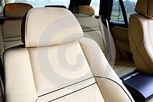 Luxury car inside. Interior of prestige modern car. Comfortable leather seats. Beige stitched leather cockpit