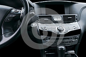 Luxury car inside. Interior of prestige modern car. Comfortable leather seats. Black perforated leather cockpit. Media control