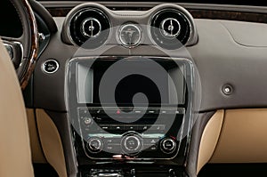 Luxury car interior. Multimedia screen and control buttons.