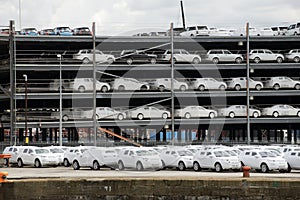 Luxury cars wrapped for protection await export at docks