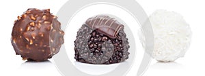 Luxury chocolate candies with hazelnuts and white cream with coconut flake round candies and dark chocolate candy on white