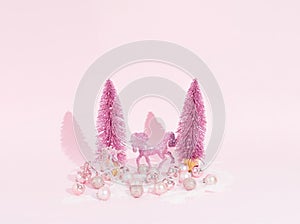 Luxury Christmas poster with shiny pink decorations, unicorn, balls and Christmas tree on a pink background. Creativ Christmas