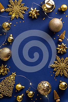 Luxury Christmas vertical banner design. Golden decorations, balls, garland lights, snowflakes on dark blue background. New Year
