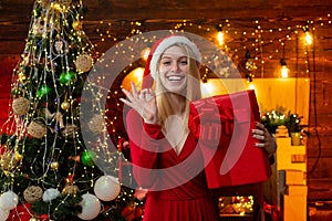 Luxury Christmas woman with gift. Fashionable luxury girl celebrating new year. Thanksgiving day and Christmas. Girl is