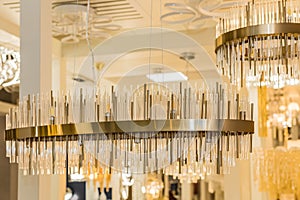 A luxury classic style chandelier is installed on the ceiling of the room