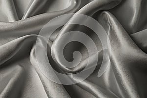 luxury cloth with drapery and wavy folds of ivory color creased smooth silk satin material texture. Abstract