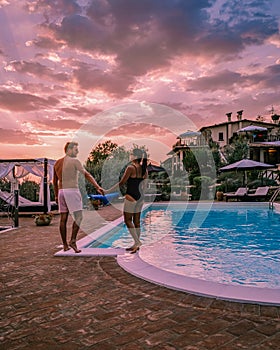 Luxury country house with swimming pool in Italy, Couple on Vacation at luxury villa in Italy, men and woman watching