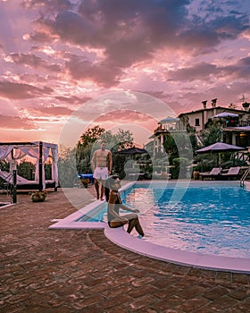 Luxury country house with swimming pool in Italy, Couple on Vacation at luxury villa in Italy, men and woman watching
