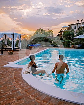 Luxury country house with swimming pool in Italy. Pool and old farm house during sunset