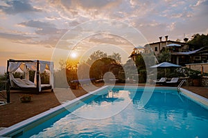 Luxury country house with swimming pool in Italy. Pool and old farm house during sunset central Italy.