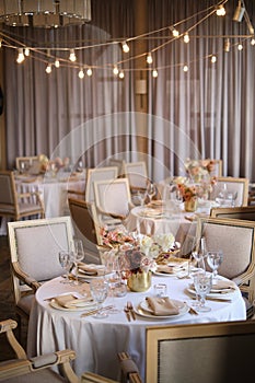 Luxury cozy autumn wedding table decoration in the restaurant. Fresh and dried flowers, roses, carnations. Beautiful table setting